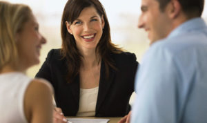 Couple talking to a consultant --- Image by © Whisson/Jordan/Corbis